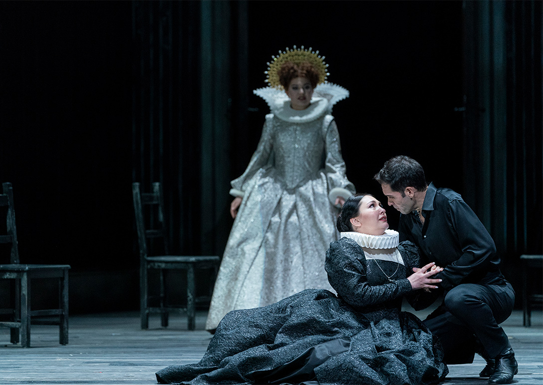 Scene from Maria Stuarda; Elisabetta in background, Maria Stuarda on floor embraced by Leicester
