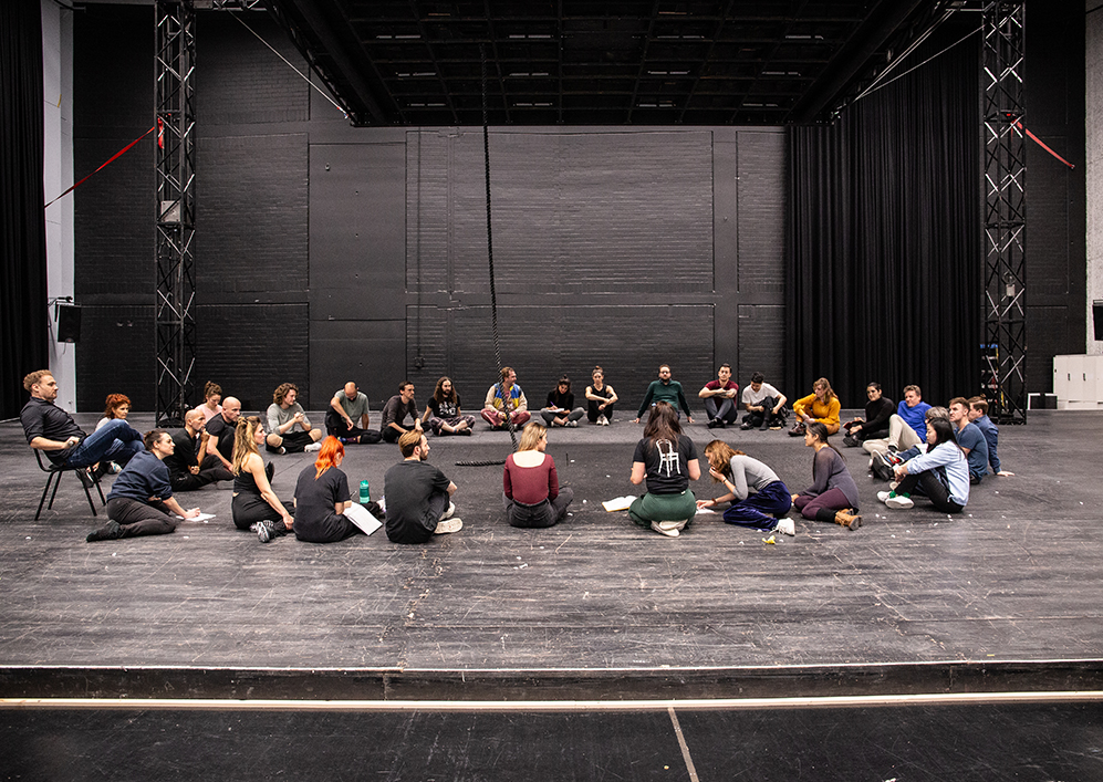 Cast and artistic team in a large circle