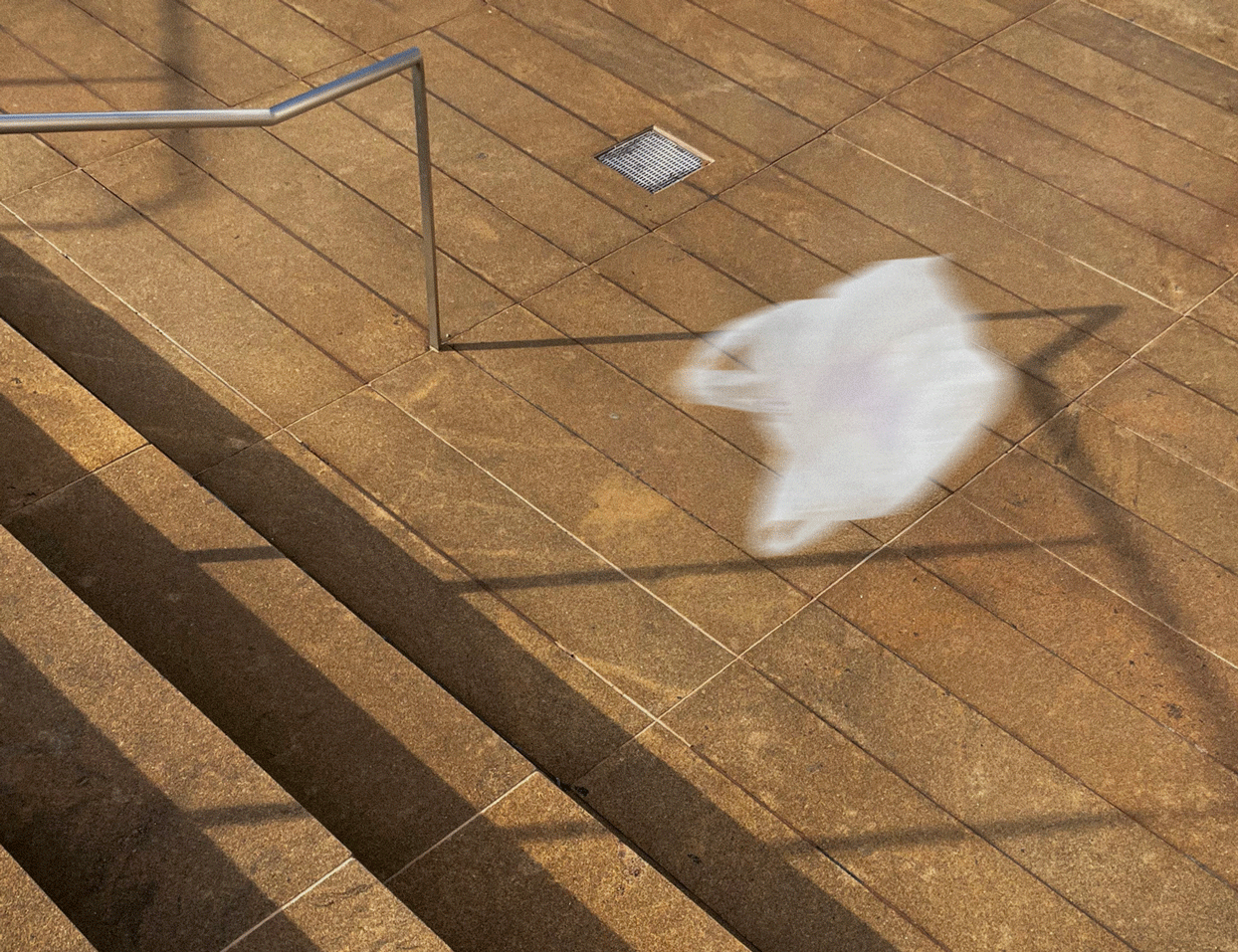 Plastic zak in de wind naast een trap