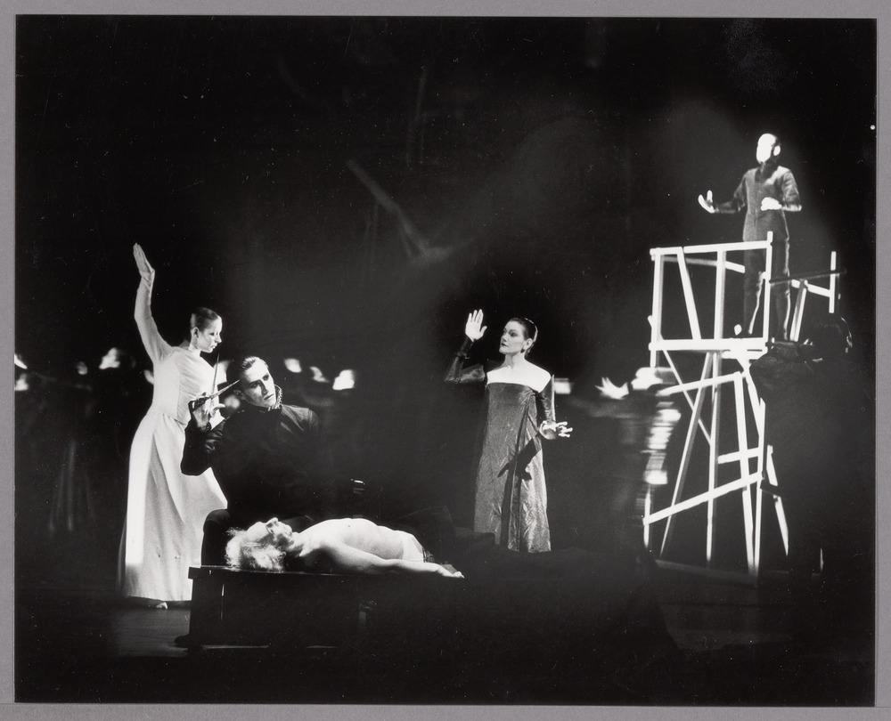 Various people in action, black and white, someone with scissors with someone laying on a table in front of him, two women gesturing and a man in a tower of wood