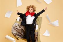 Boy in conductor costume with flying scores