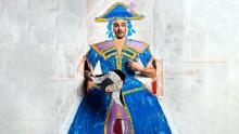 Man in cardboard cutout with costume painted on